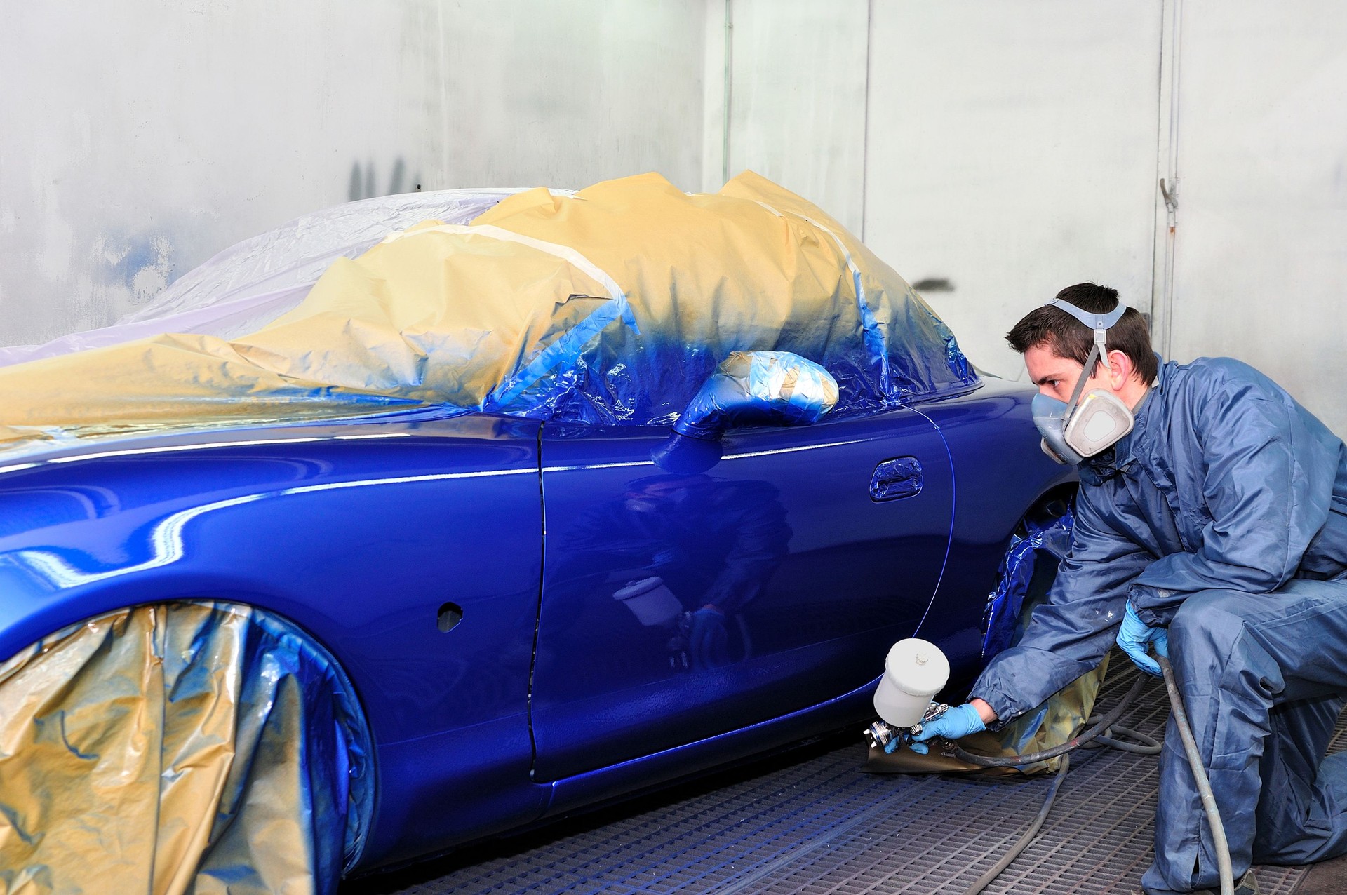 Man painting a car.